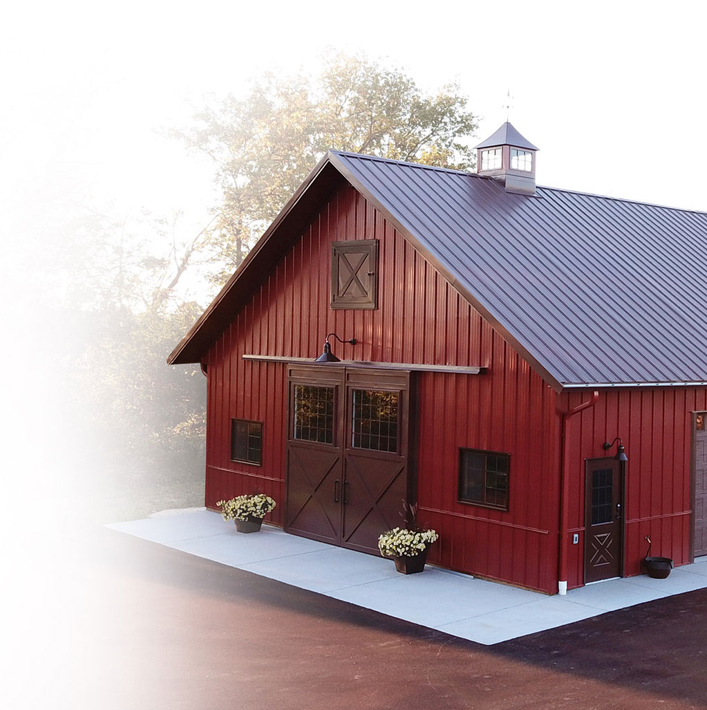 Custom Steel Building Design and Craftsmanship | Walters Buildings Custom steel building by Walters Buildings with vertical siding, cupola, and decorative doors