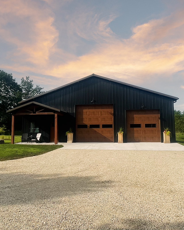 Custom Steel Building Design and Construction | Walters Buildings Custom steel building designed and constructed by Walters Buildings with overhead doors and covered porch